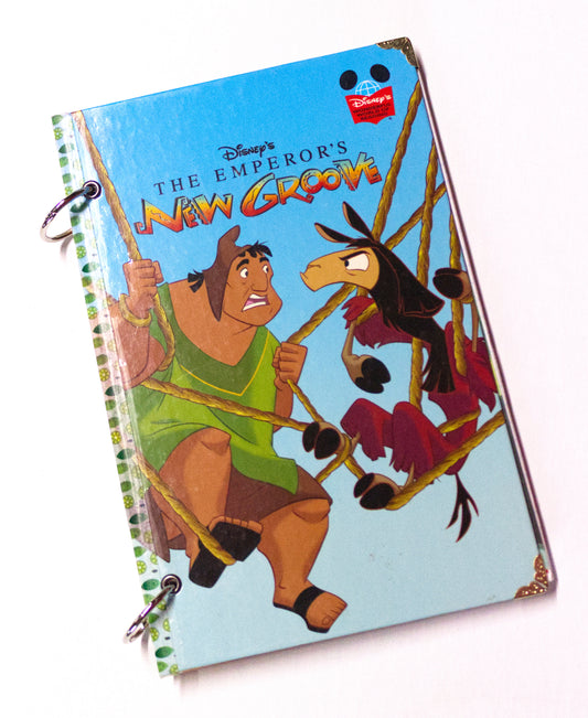 Upcycled children’s book journal made from The Emperor’s New Groove hardcover, featuring Pacha and Kuzco on the front cover.