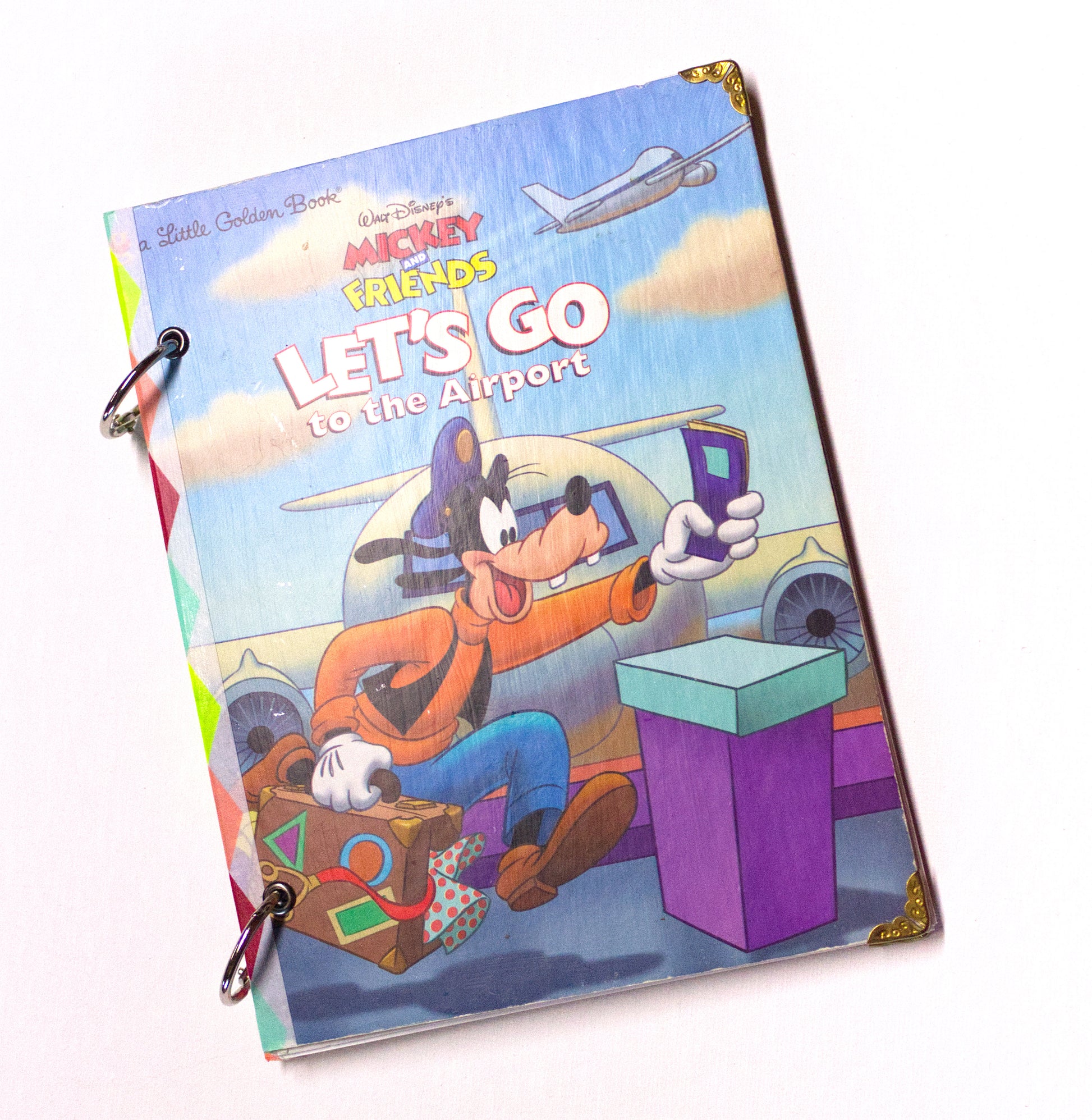 Upcycled children’s book journal made from Let’s Go to the Airport hardcover, featuring Goofy.