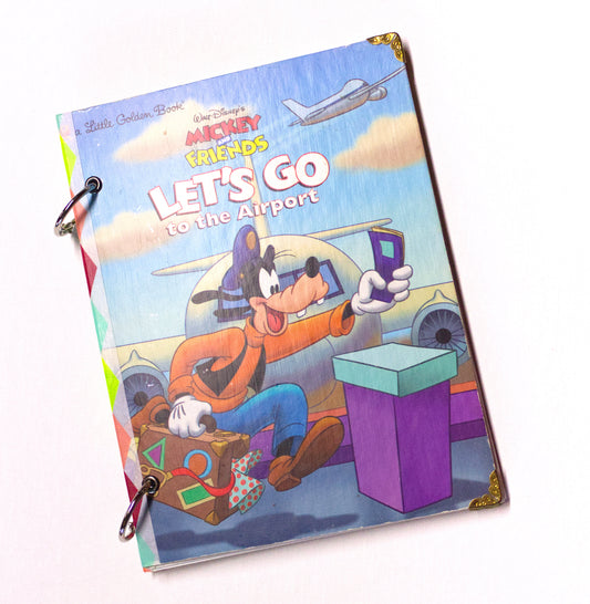 Upcycled children’s book journal made from Let’s Go to the Airport hardcover, featuring Goofy.