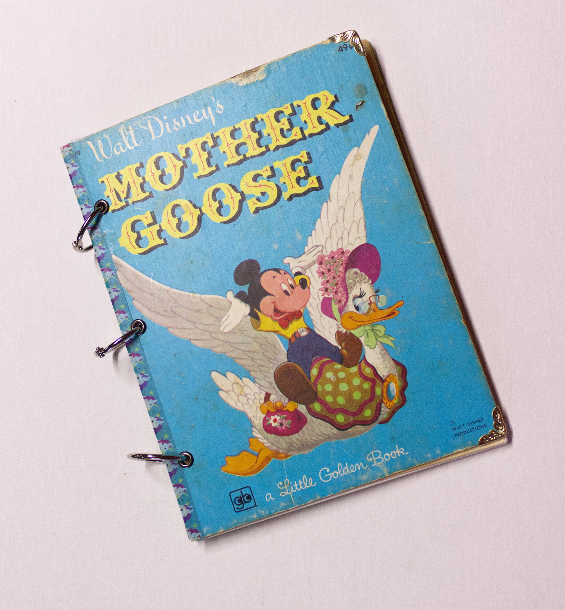 Upcycled children’s book journal made from a Mother Goose hardcover, featuring Mickey Mouse and Mother Goose on the front cover.
