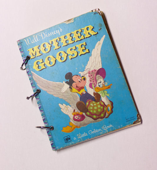 Upcycled children’s book journal made from a Mother Goose hardcover, featuring Mickey Mouse and Mother Goose on the front cover.