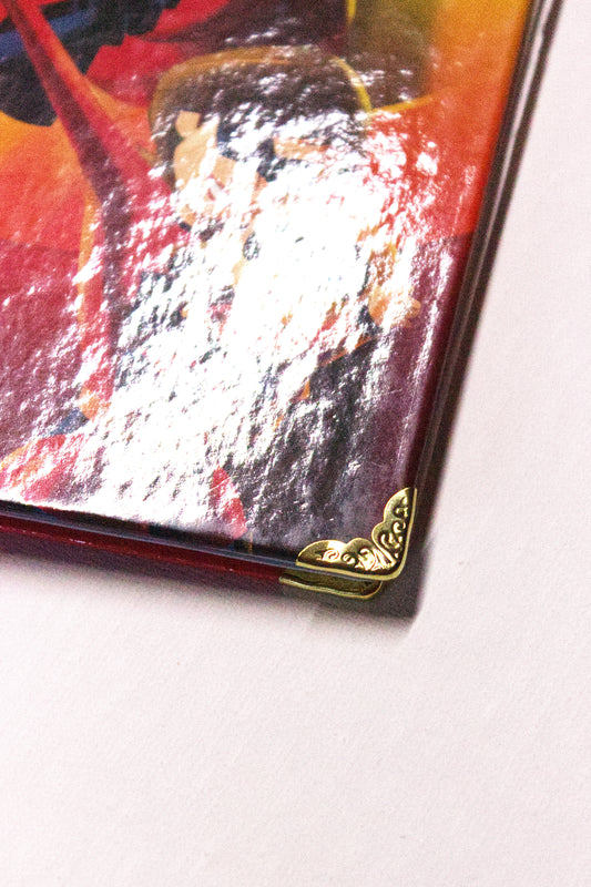 Side view of an upcycled The Incredibles journal showing layered pages and ring binding.
