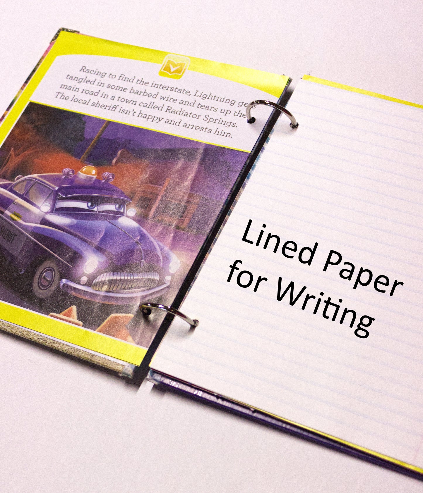 Interior pages of an upcycled Cars book journal showing lined pages for journaling.