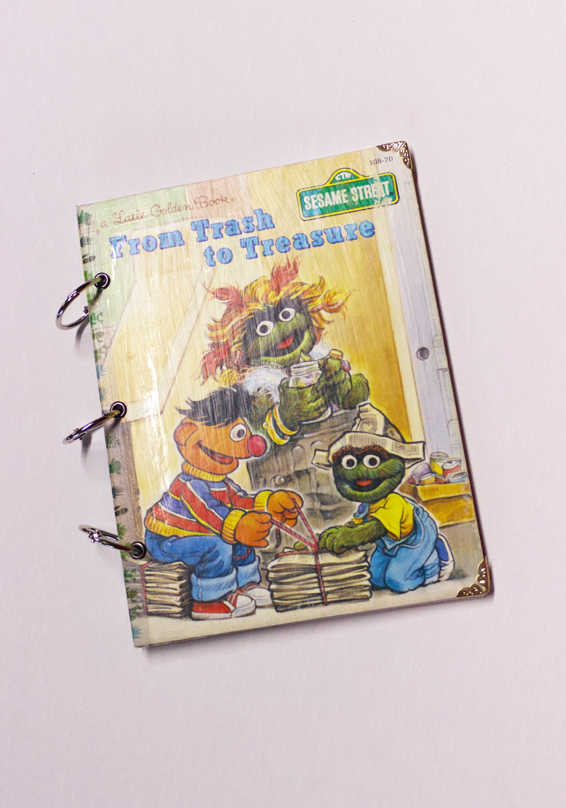 Upcycled children’s book journal made from Trash to Treasure hardcover, featuring Sesame Street characters on the front cover.