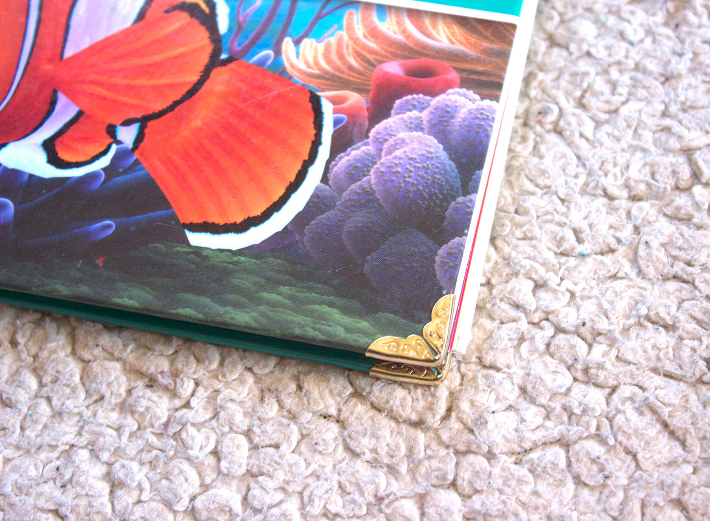 Close up on the reinforced gold corners on the Finding Nemo handmade Upcycled book journal showing