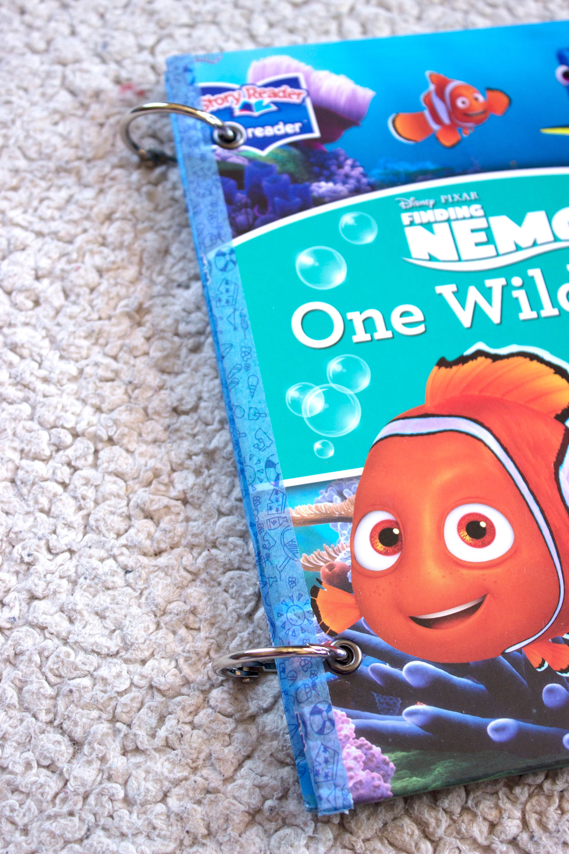 Side view of an upcycled The Incredibles journal showing layered pages and ring binding.